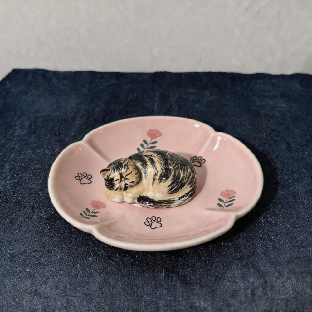 Pink cat on a lotus pet ring dish