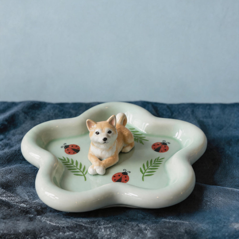 Green dog on a star-shaped pet ring dish