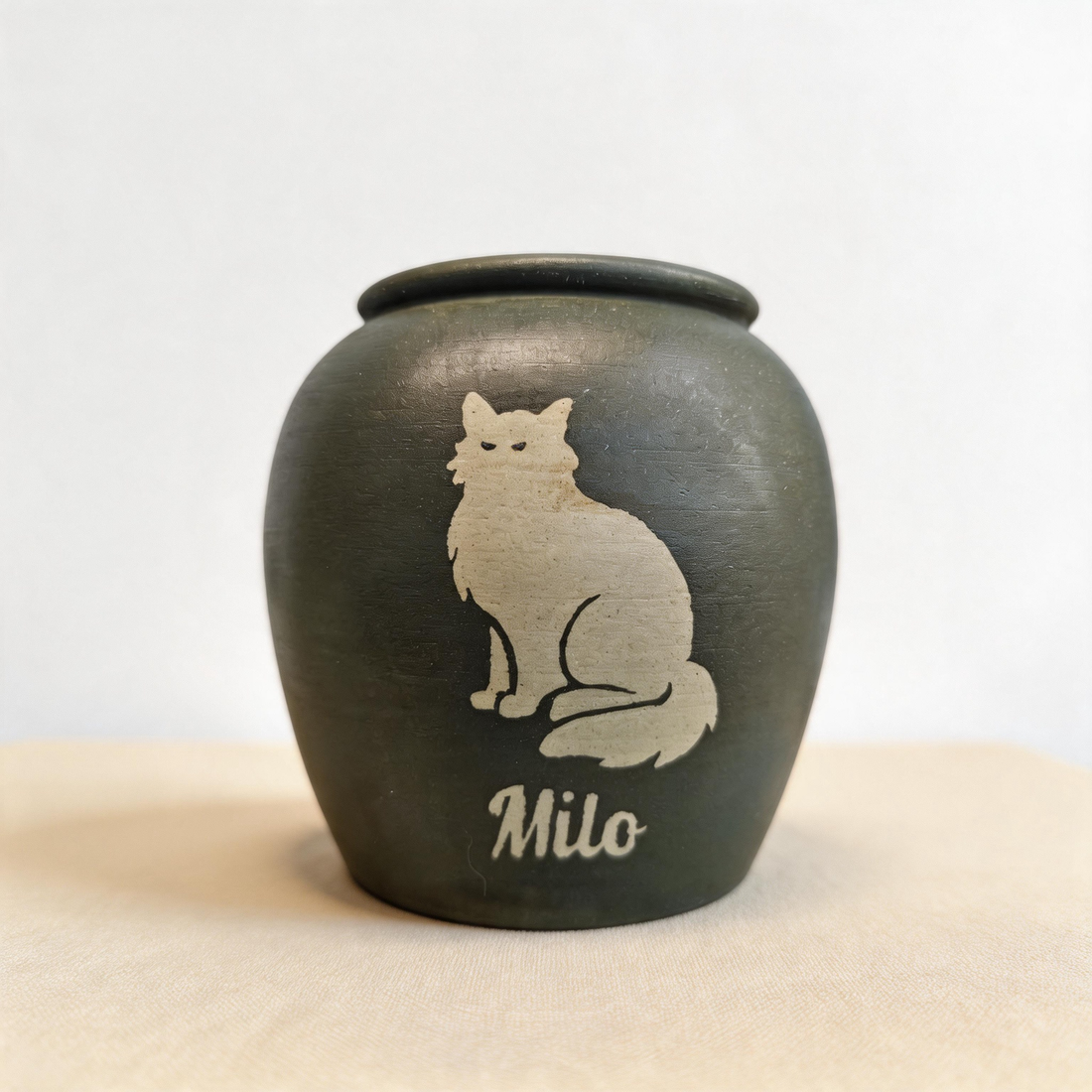 Hand-painted ceramic urn with a long-haired cat silhouette by Farbe Ceramics, a keepsake in the likeness of a fluffy Maine Coon style cat