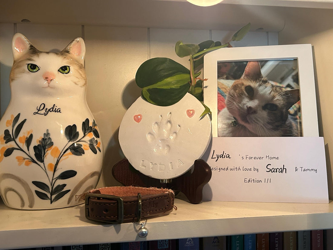 Handmade ceramic cat shaped urn for pet ashes, hand painted to match the cat's coat