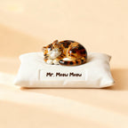 Three-quarter view of a personalized cat pillow urn for ashes — a handmade ceramic cat memorial urn, hand-painted from your photos to match your cat and made to order. Custom pet memorial by Farbe Ceramics.