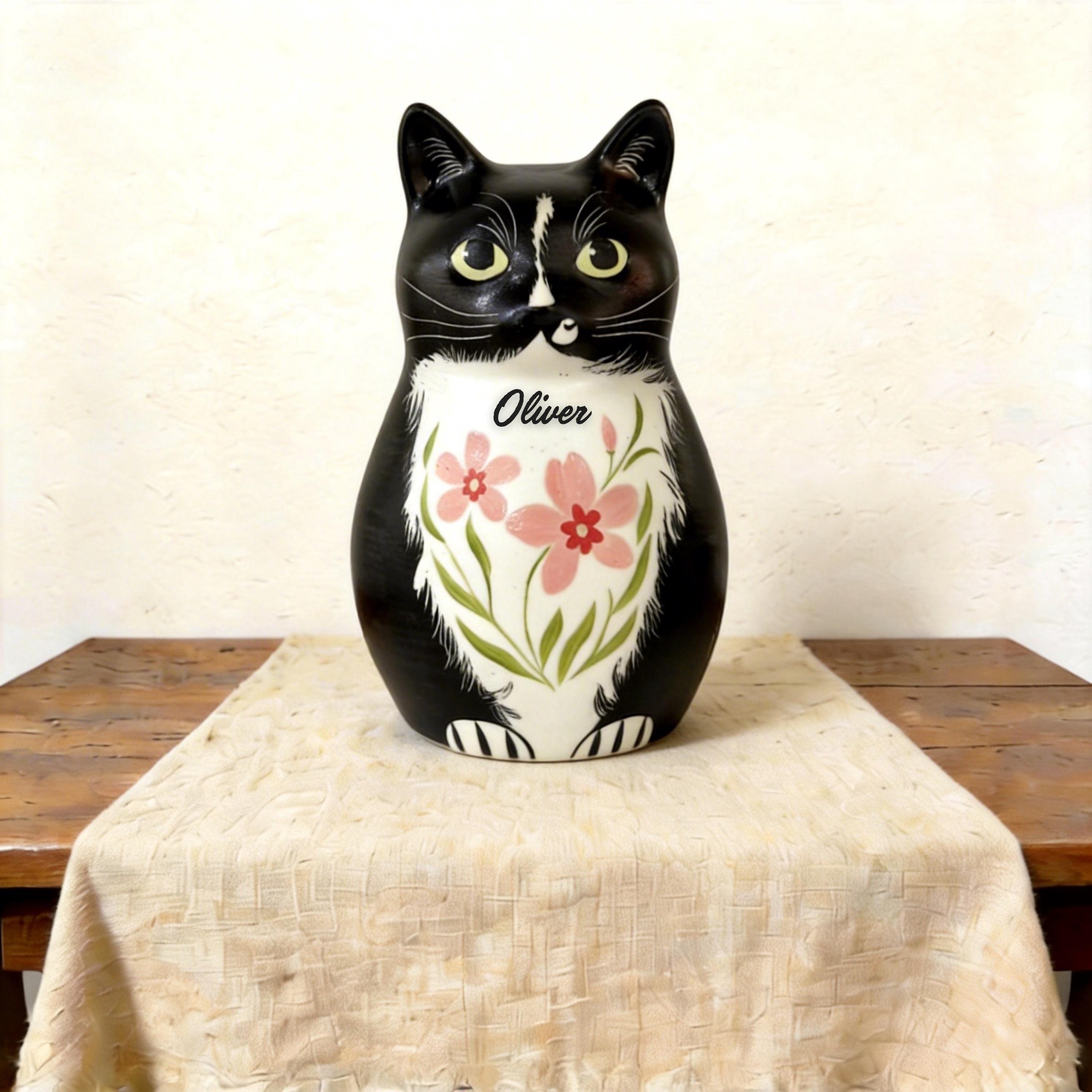 Front view of a cat-shaped urn for human ashes — a handmade ceramic cat lover cremation urn, hand-painted and personalized, made to order from keepsake to full sizes by Farbe Ceramics.