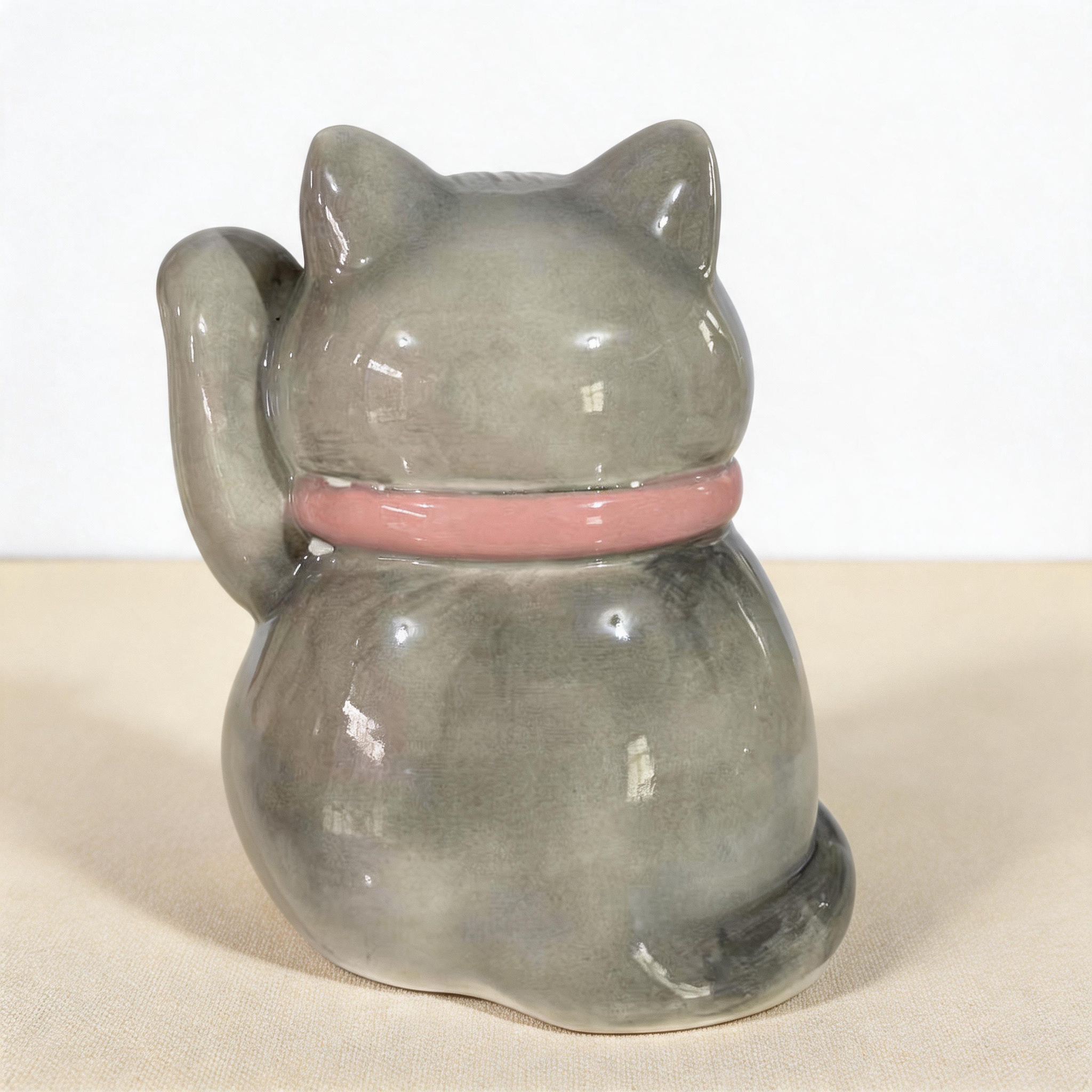Shown with name and dates of a personalized maneki neko lucky cat urn for ashes — a handmade ceramic cat memorial urn, hand-painted from your photos to match your cat and made to order. Custom pet memorial by Farbe Ceramics.