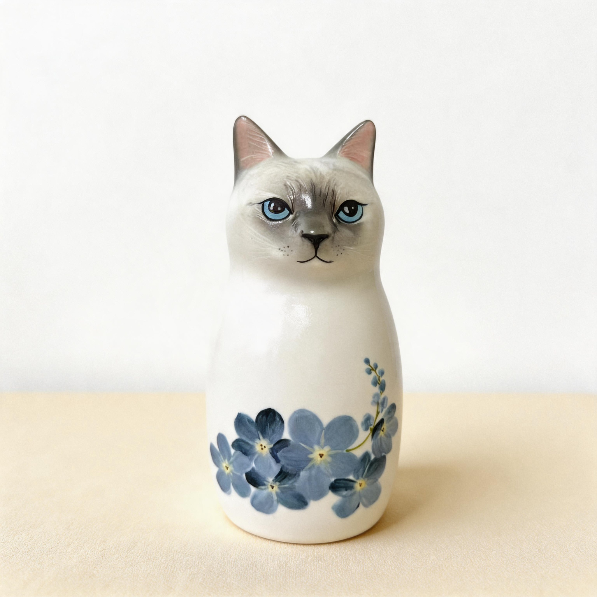 Siamese custom cat urn for ashes — a handmade, hand-painted ceramic cat cremation urn, custom made to order from your photos and personalized with name and dates. Pet memorial keepsake by Farbe Ceramics.