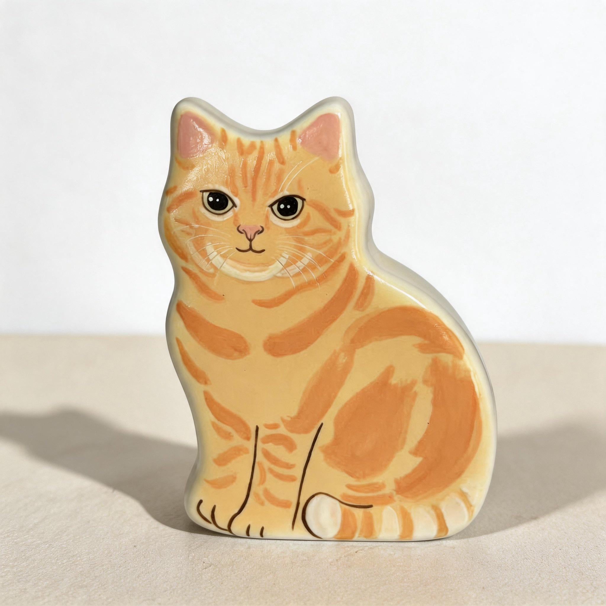Close-up of the hand-painted detail of a personalized flat pet urn for ashes — a handmade ceramic pet memorial urn, hand-painted from your photos to match your pet and made to order. Custom pet memorial by Farbe Ceramics.